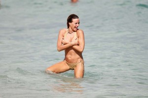 Kelly Bensimon in brown bikini
