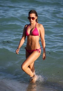 Model Sylvie Meis wears a hot pink string bikini as she hits the beach in Miami